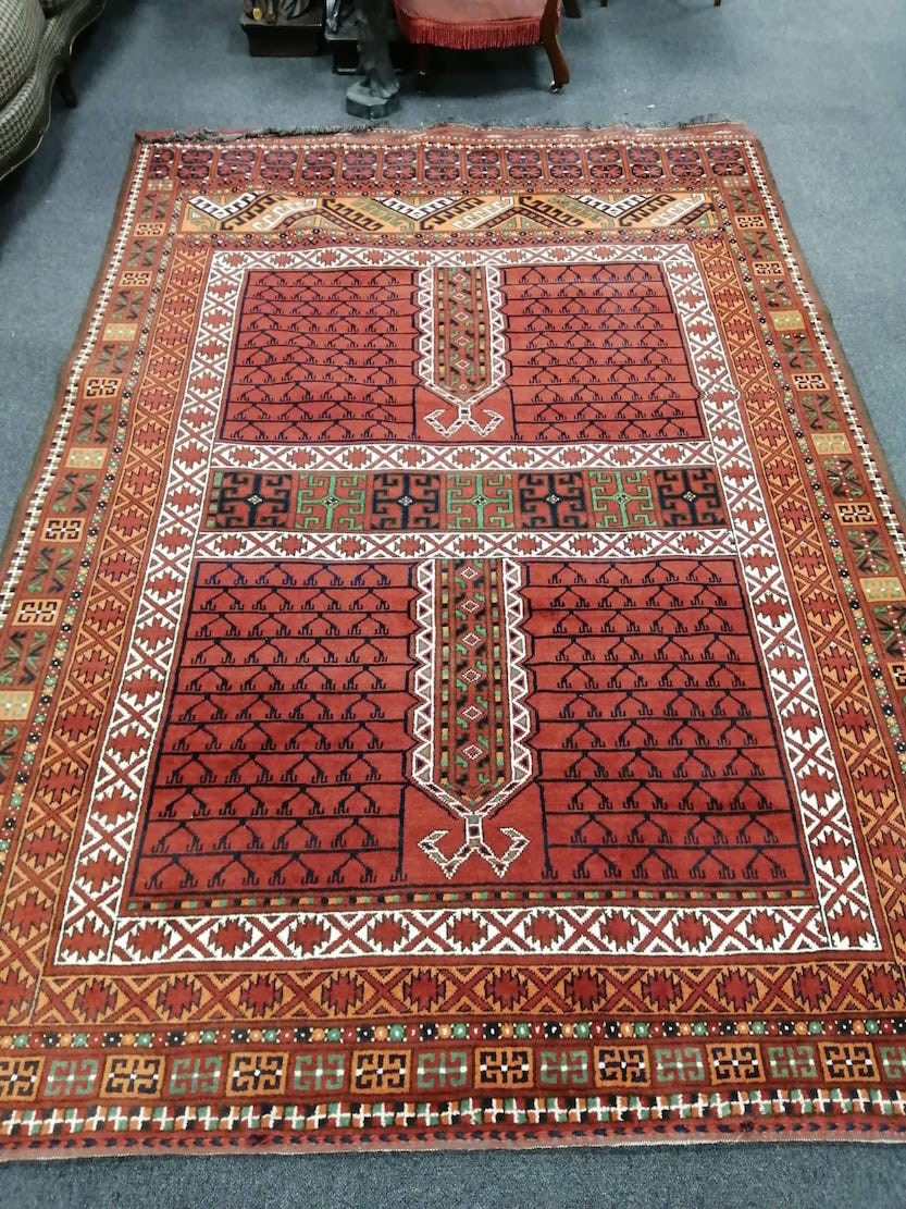 An Afghan red ground rug, 248 x 174cm